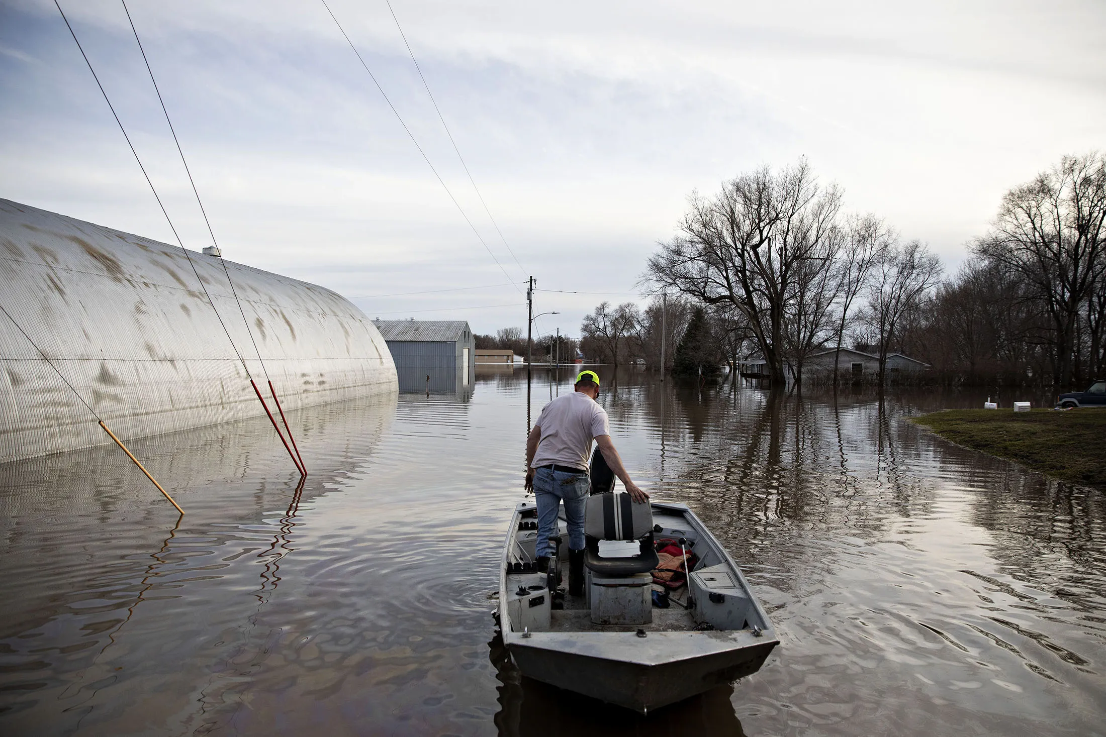 A resident launches a boat into floodwaters in Hamburg, Iowa, on&nbsp;March 22.