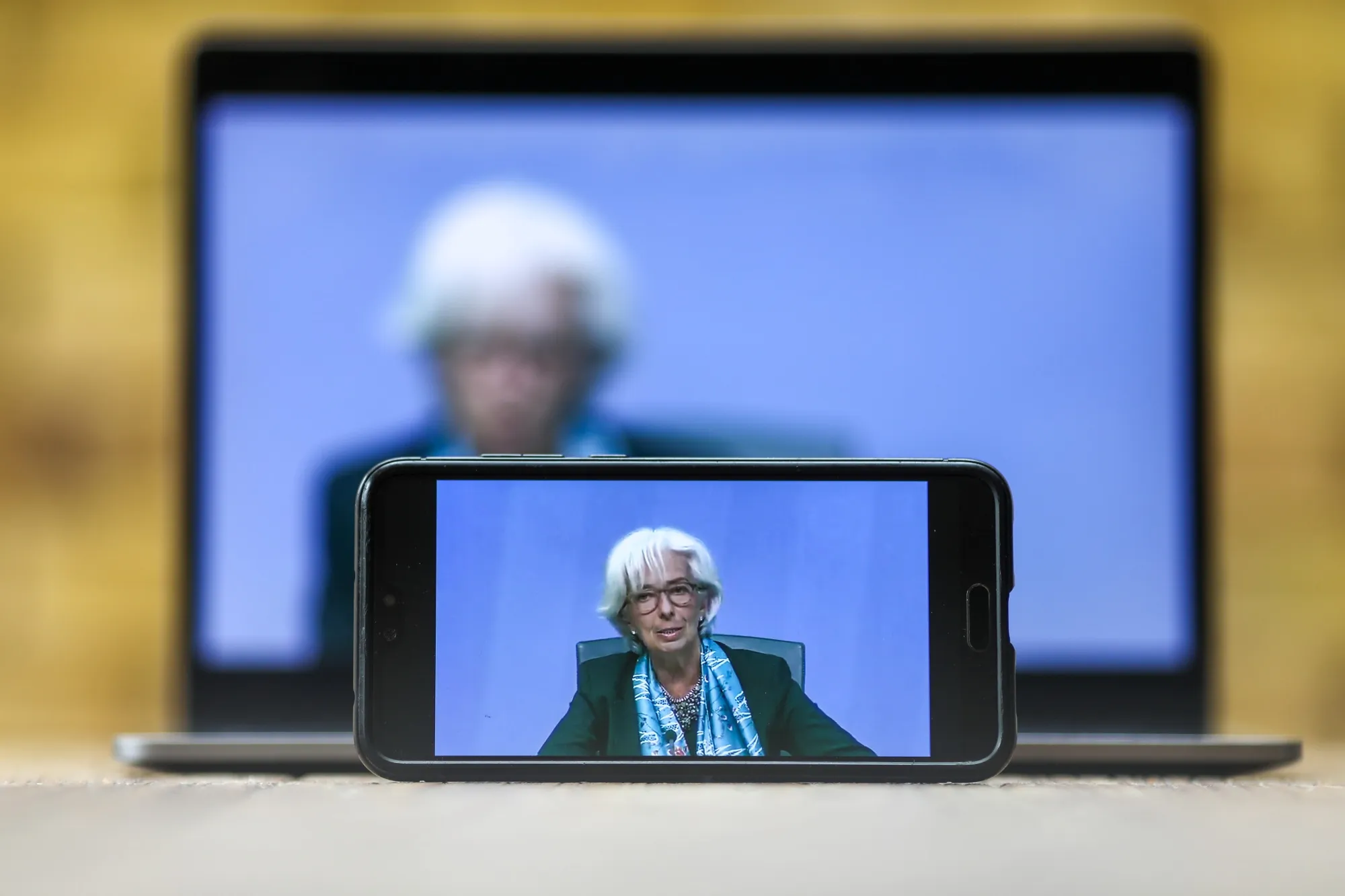 ECB President Christine Lagarde&nbsp;is displayed on a mobile phone and laptop computer during a live stream video of the central bank's virtual rate decision news conference in Frankfurt&nbsp;on&nbsp;June 4, 2020