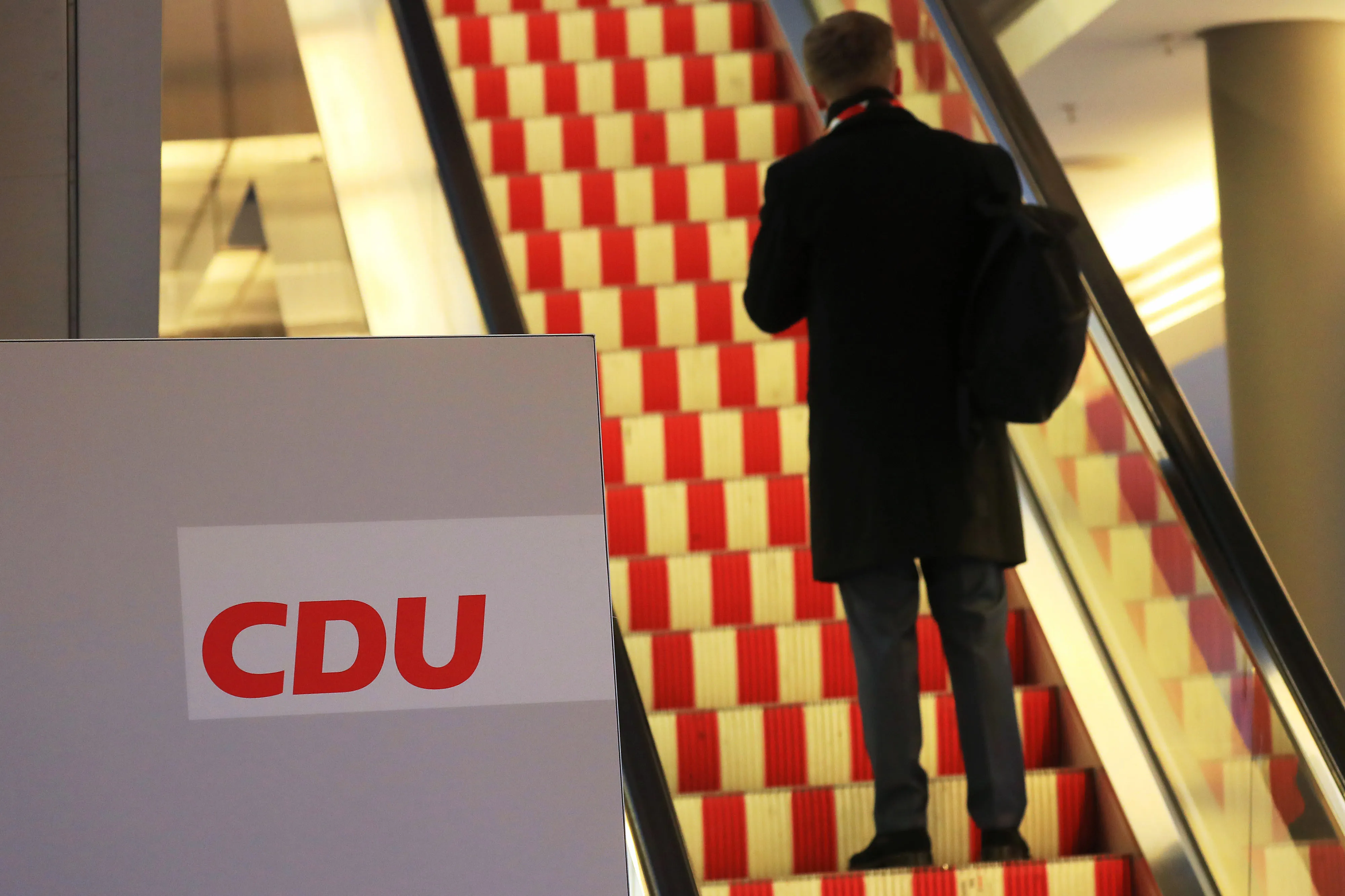An attendee stands on a an escalator ahead of the Christian Democrat Union convention in Leipzig, on Nov. 22.