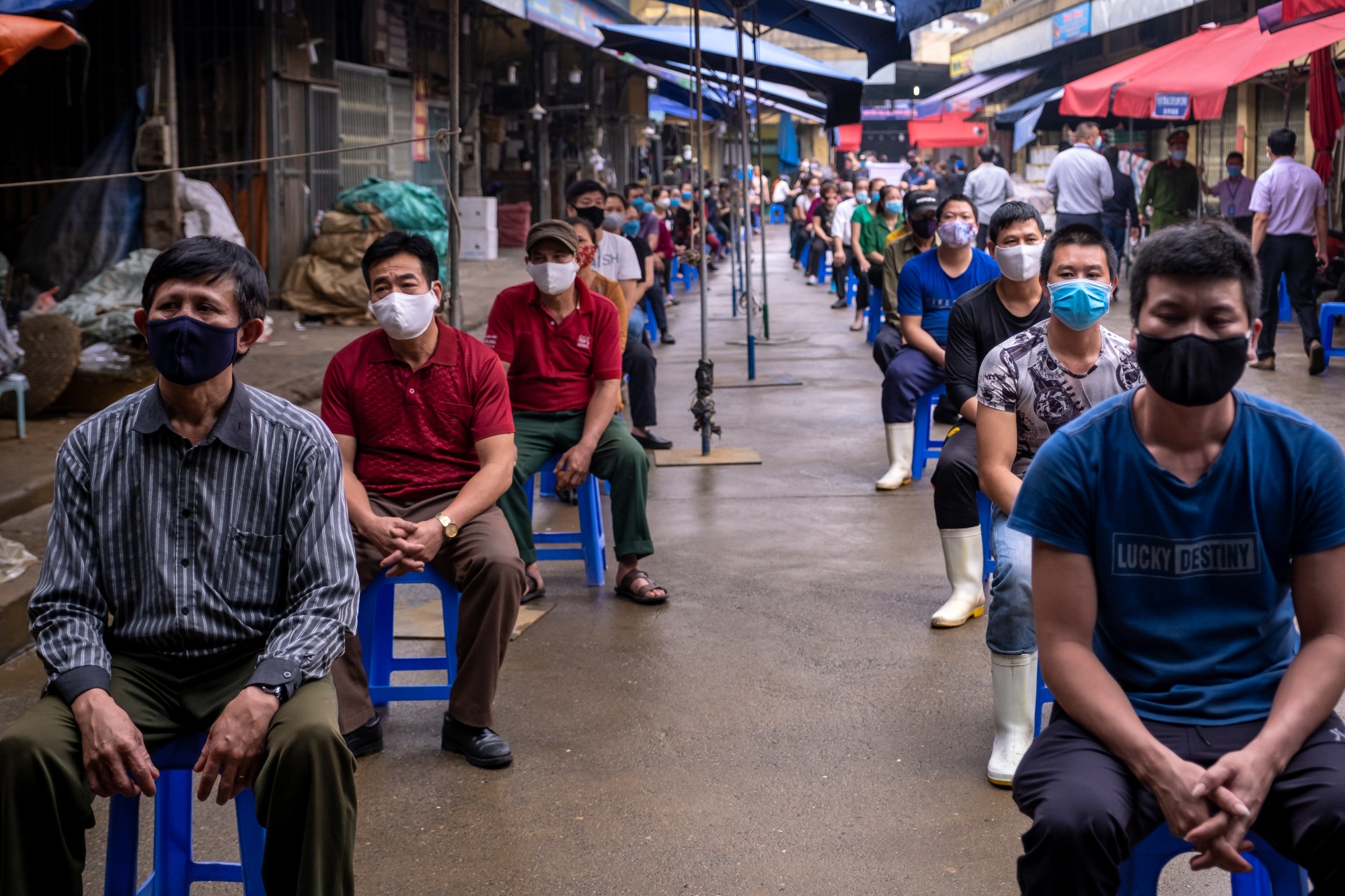 Workers from Long Bien market line up to be tested for Covid-19 in Hanoi, April 2020.