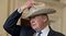President Donald Trump puts on a Stetson cowboy hat while participating in a “Made in America” event at the White House in Washington on July 17, 2017.