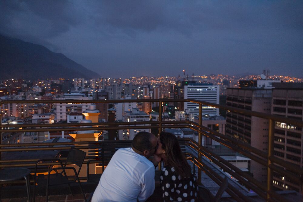 Romance at the 360 Caracas rooftop bar, overlooking the lights—which are on, for the moment—of the capital.