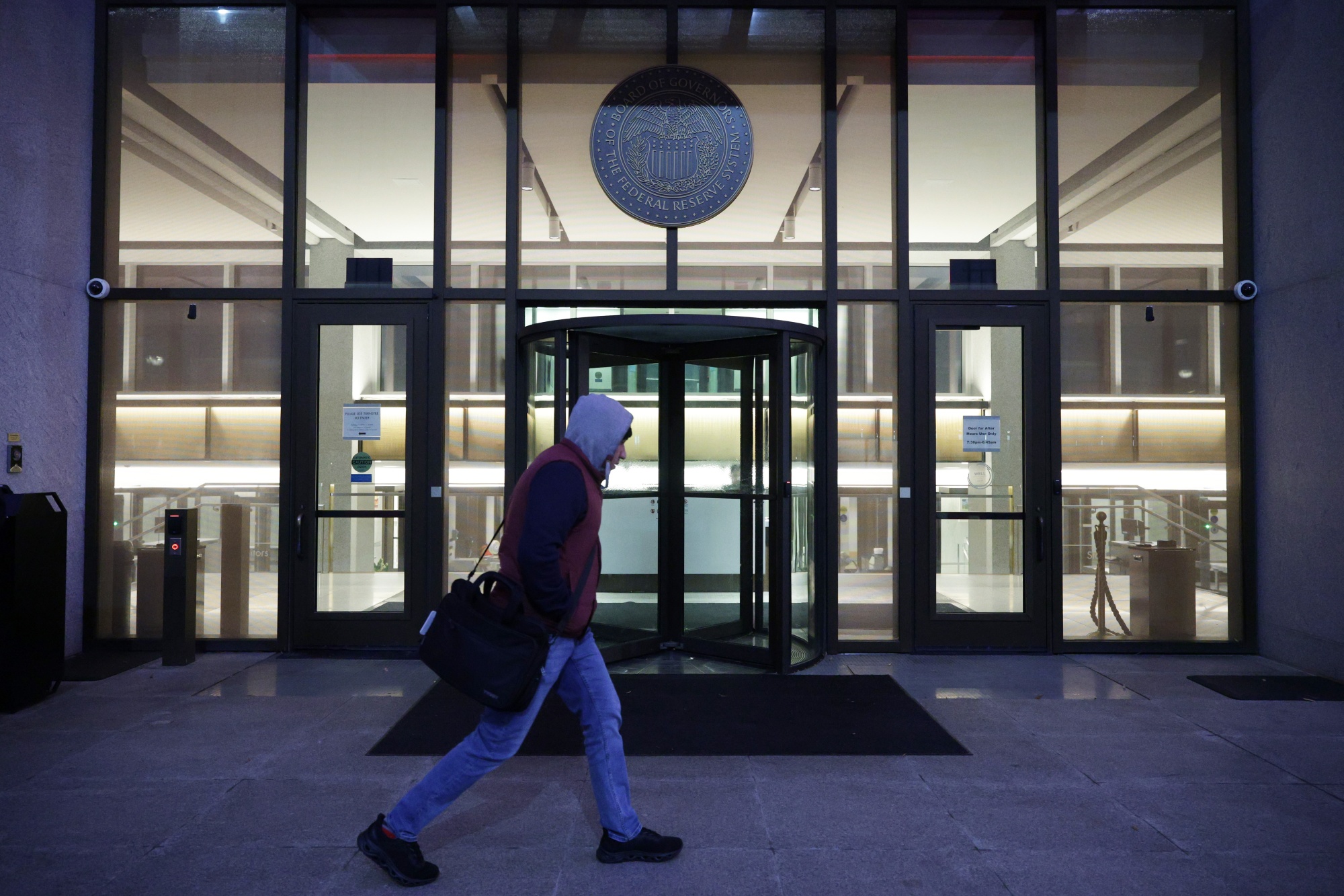 A man passes by the William McChesney Martin Jr. Building of the Federal Reserve Board on Jan. 14, 2026, in Washington.
