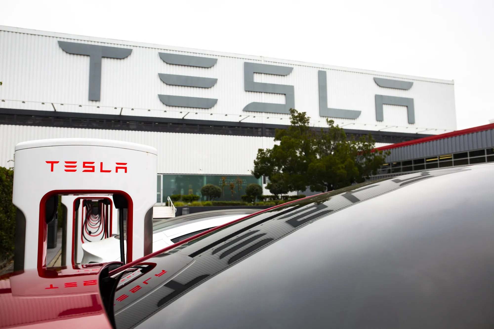 Tesla Inc. electric vehicles charge at the Tesla Supercharger station in Fremont, California.