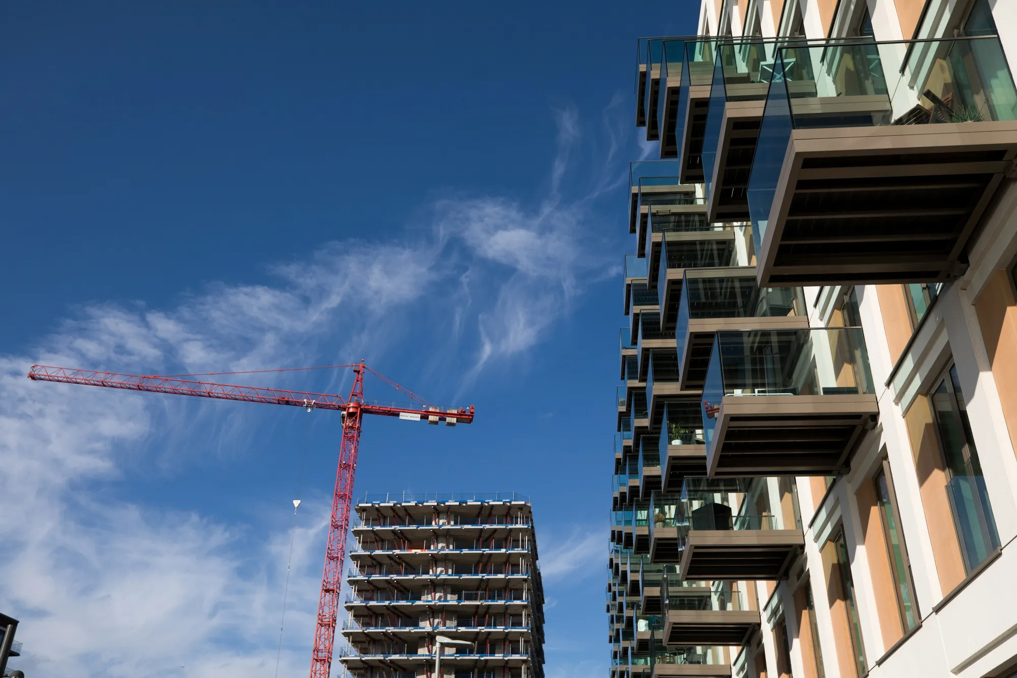 A crane stands over a residential apartment block under construction&nbsp;in London.