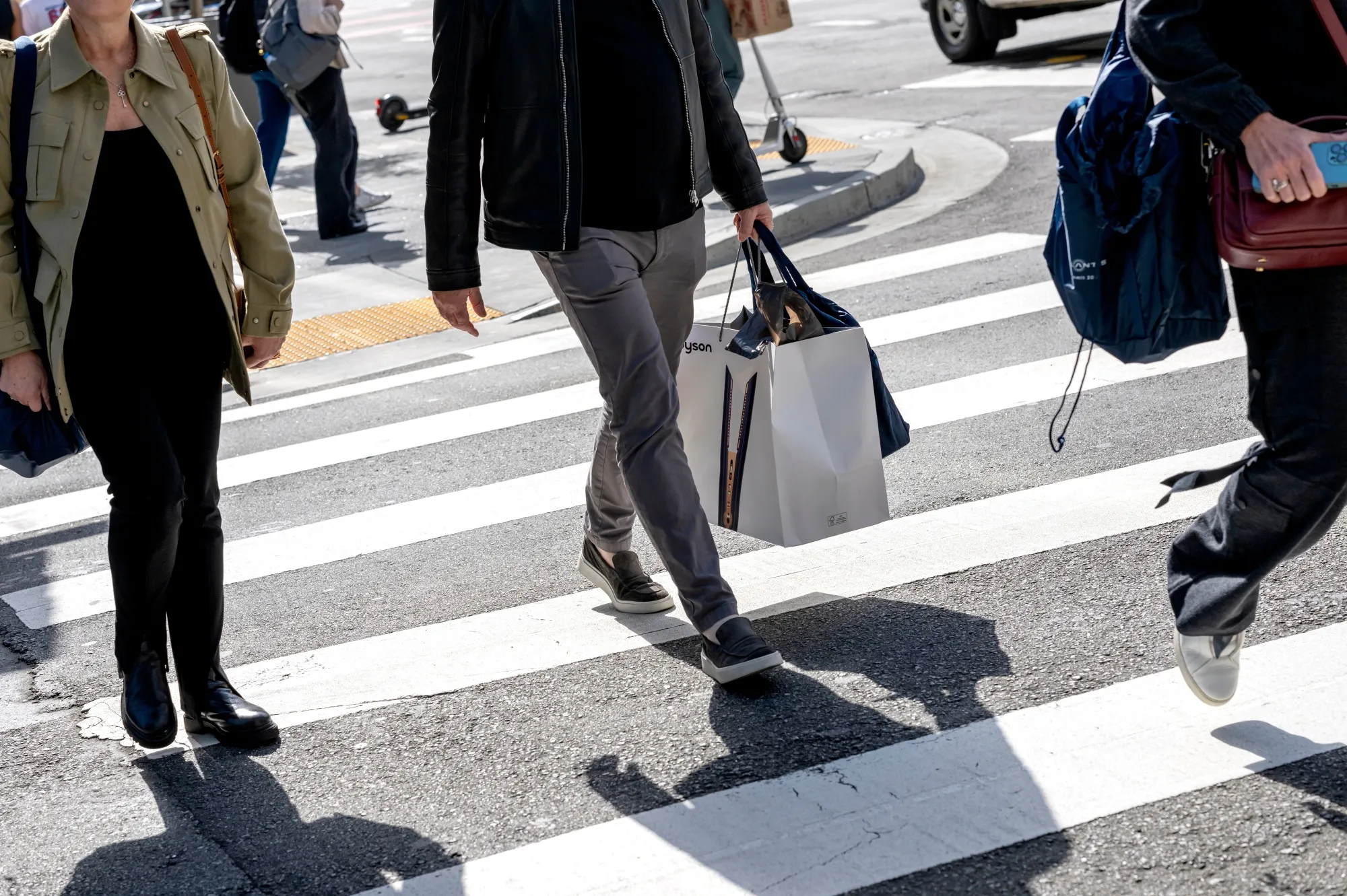 A shopper carries shopping bags in San Francisco, California.