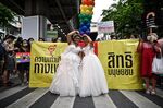 A same sex couple poses in wedding dresses during the Pride March in Bangkok on June 5.