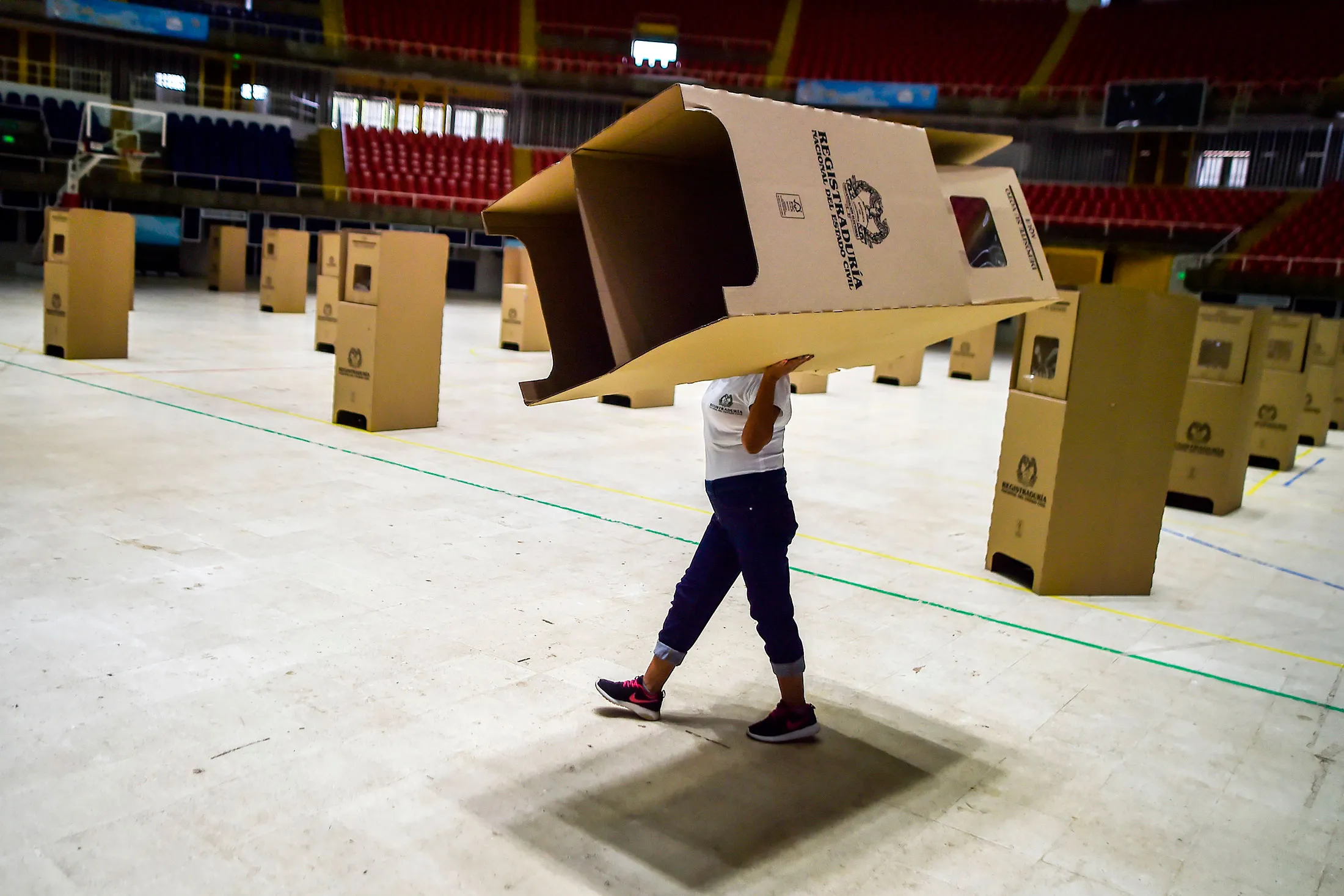 Un trabajador monta las cabinas de votación en un colegio electoral de Cali, Colombia, en 2018.