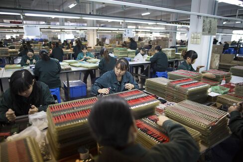 Workers assemble mechanical pencils at s stationery factory in Guangzhou.