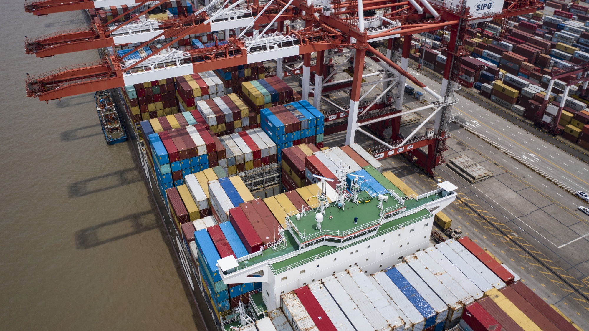 A vessel loaded with shipping containers is docked at the Yangshan Deepwater Port in this aerial photograph taken in Shanghai.