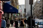 Pedestrians pass along Rue de Rennes in Paris on Feb. 24.