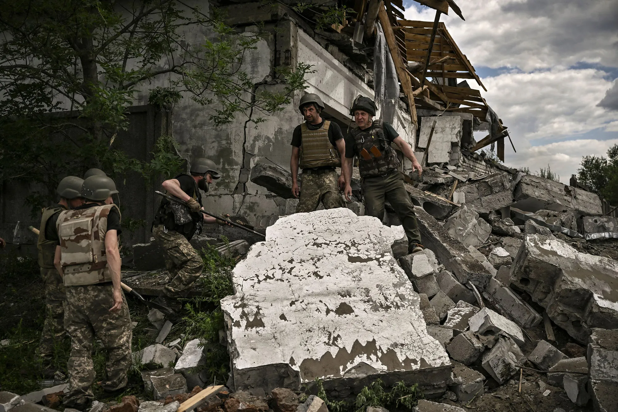 Ukrainian soldiers inspect a destroyed warehouse targeted by Russian forced on the outskirts of Lysychansk, eastern Ukrainian.
