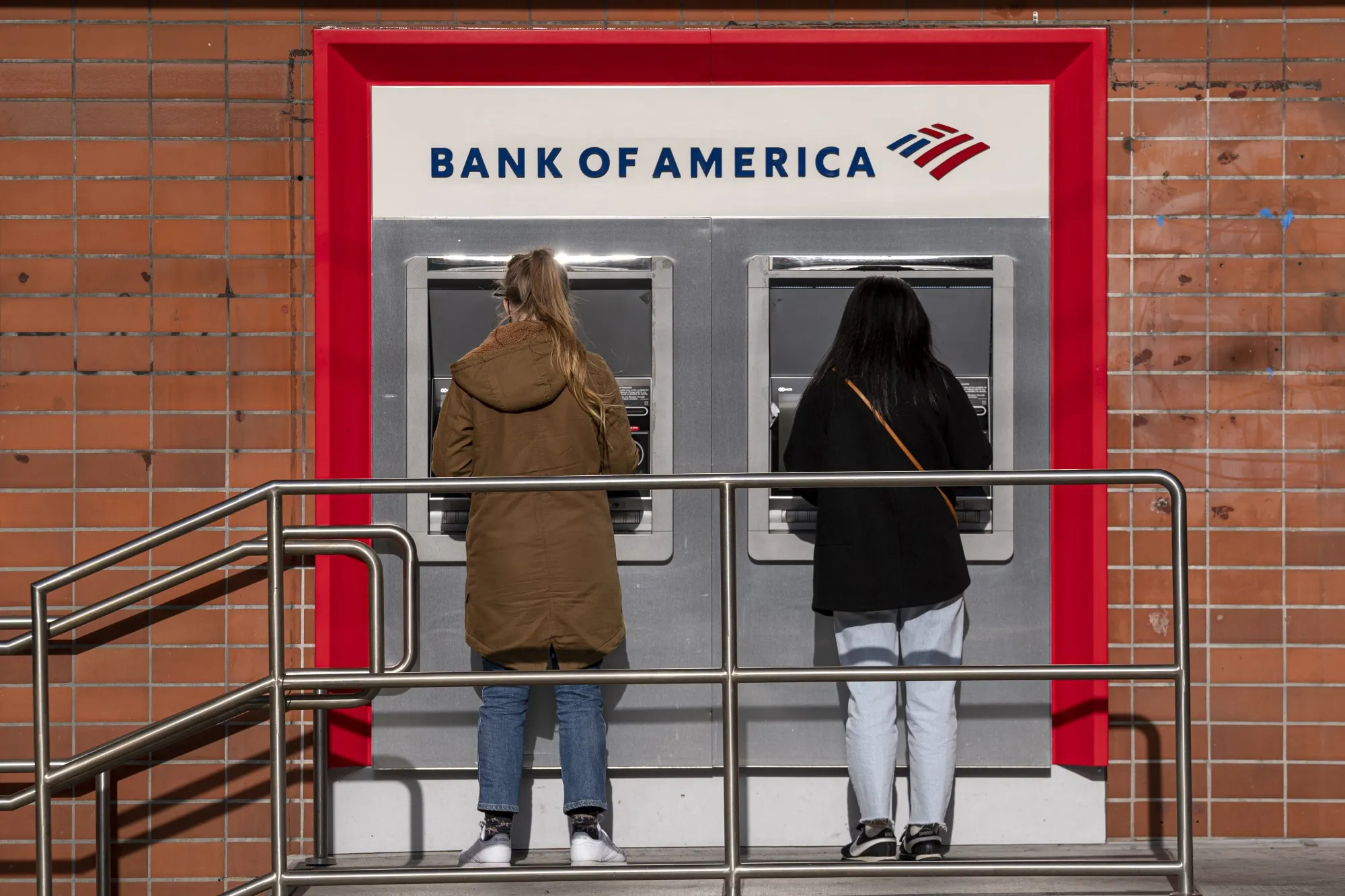 People use an ATM at a Bank of America branch in San Francisco.
