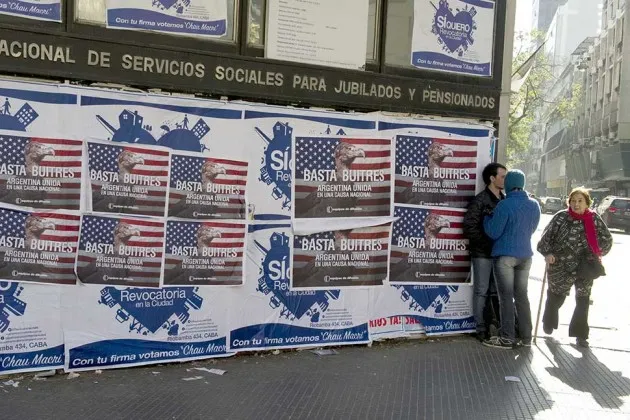 Posters against the “vulture funds” on a wall in Buenos Aires on June 18