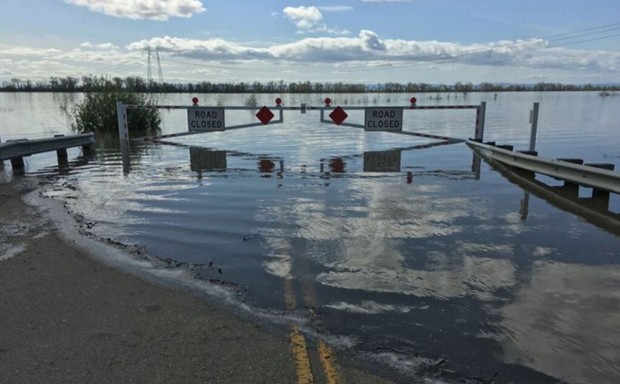 A bridge lies submerged north of Sacramento after recent heavy rains.