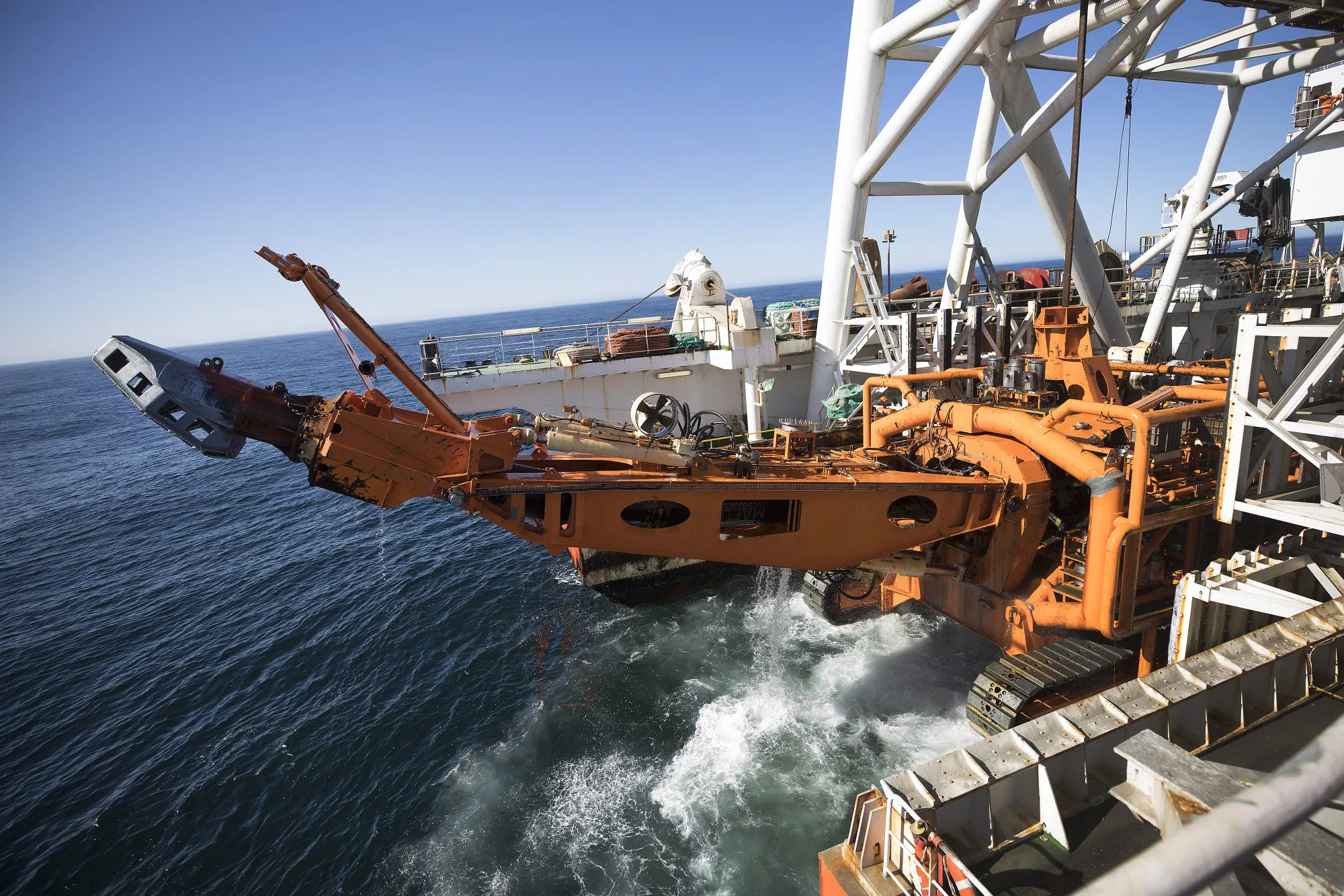 The 'crawler' tractor drops into the sea from the deck of the Mafuta diamond mining vessel.