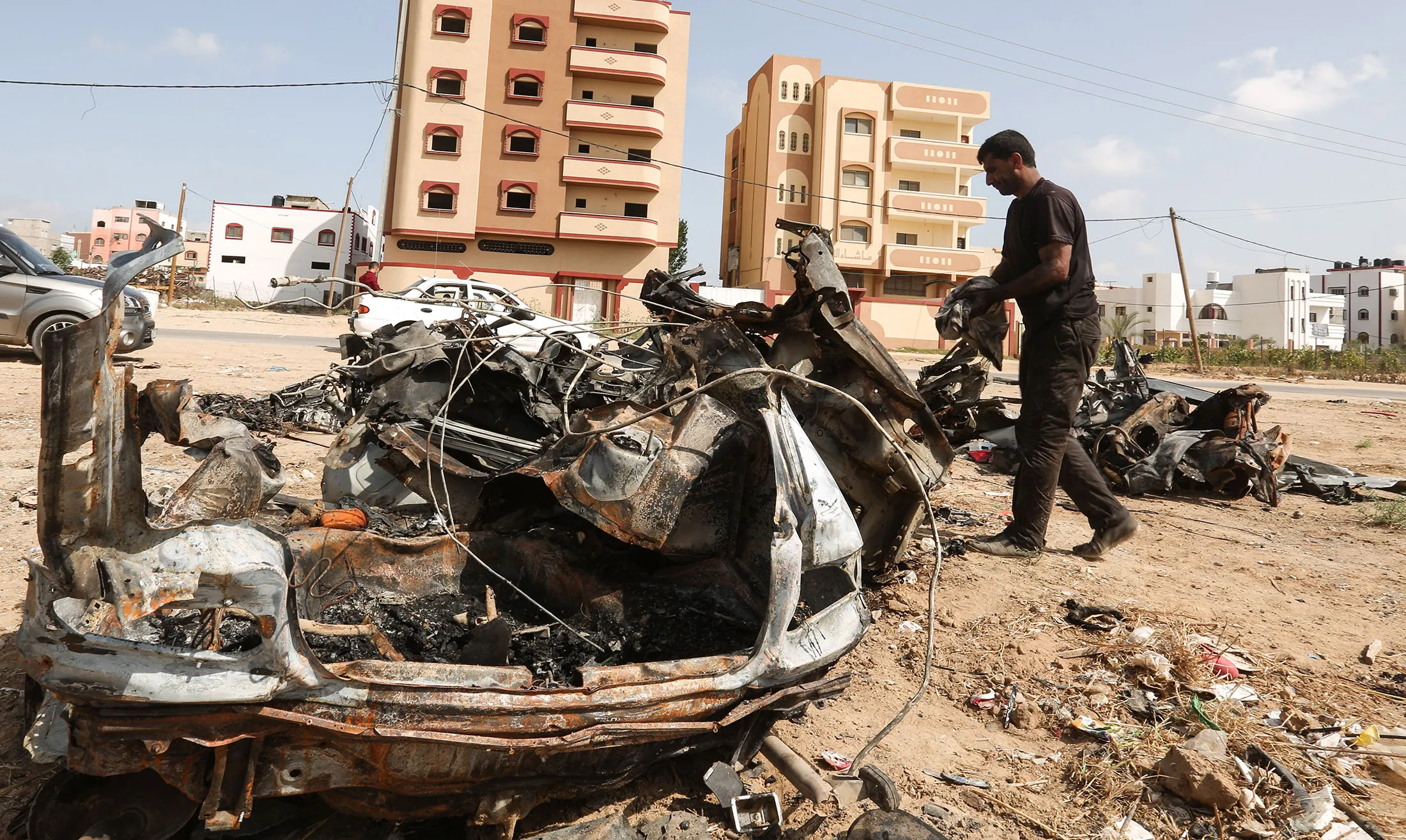 A Palestinian man inspects a destroyed car after an Israeli air strike in al-Shujaiyya neighbourhood&nbsp;in the Gaza Strip&nbsp;on June 17.