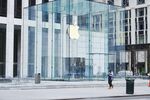 A pedestrian passes in front of an Apple store in New York, U.S., on March 20.&nbsp;