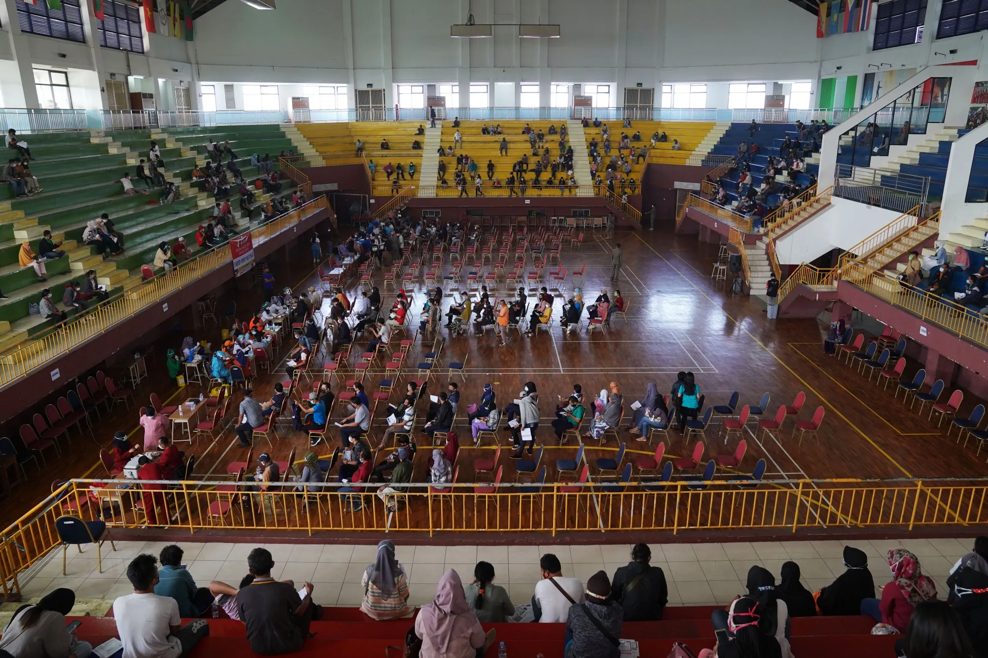 Members of the public wait to receive a Covid-19 vaccine at a center set up at GOR Ciracas Stadium in Jakarta, Indonesia.