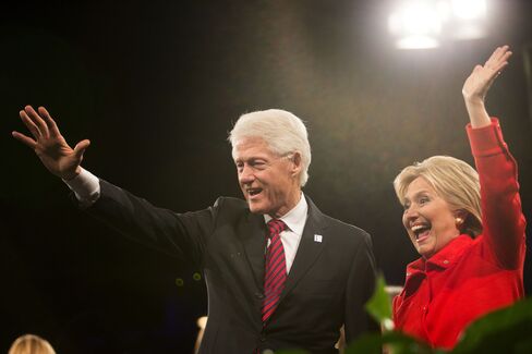 Hillary Clinton waves to supporters with her husband, former President Bill Clinton, at the conclusion of the Jefferson-Jackson Dinner in Des Moines, Iowa, on Oct. 24, 2015.