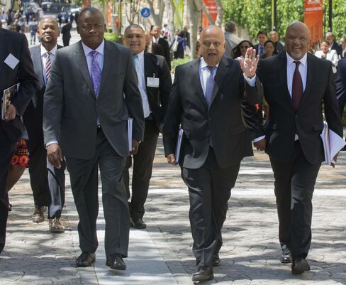 Lungisa Fuzile, left, and Pravin Gordhan, center.