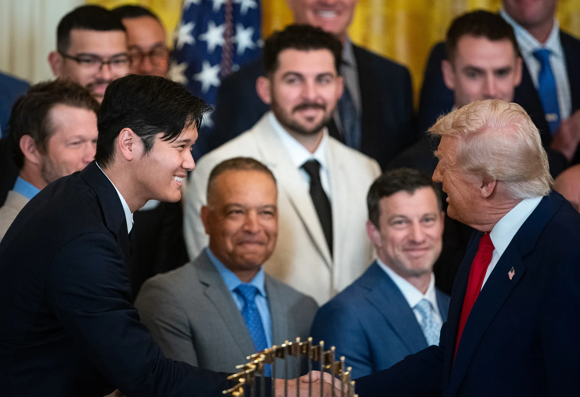 US President Donald Trump, right, and Shohei Ohtani, pitcher with the Los Angeles Dodgers, shake hands in the East Room of the White House in Washington, DC, US, on Monday, April 7, 2025. Trump hosted&nbsp;the Los Angeles Dodgers to celebrate their 2024 World Series victory.