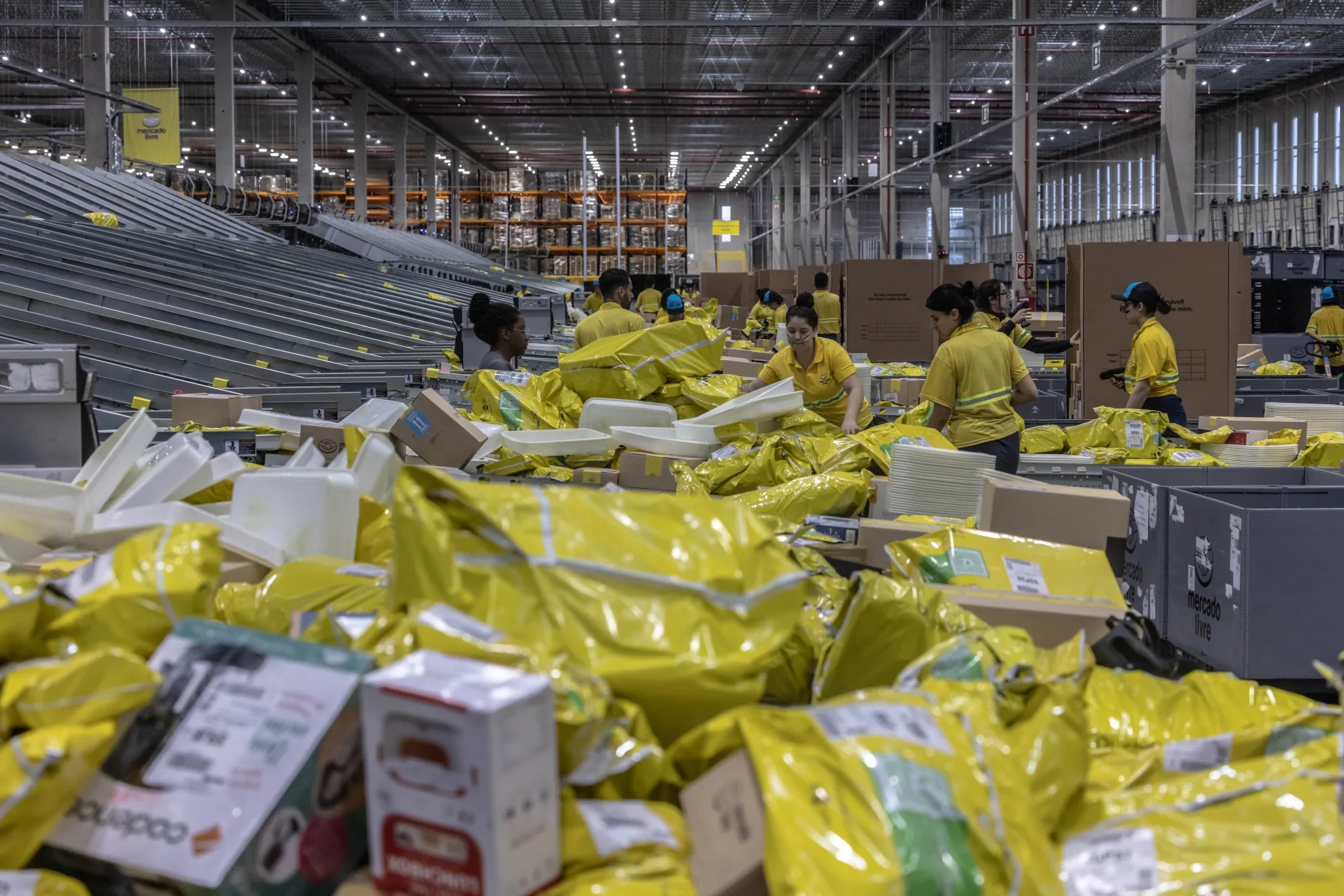 Workers sort packaged products at the MercadoLibre fulfillment center in Sao Paulo.
