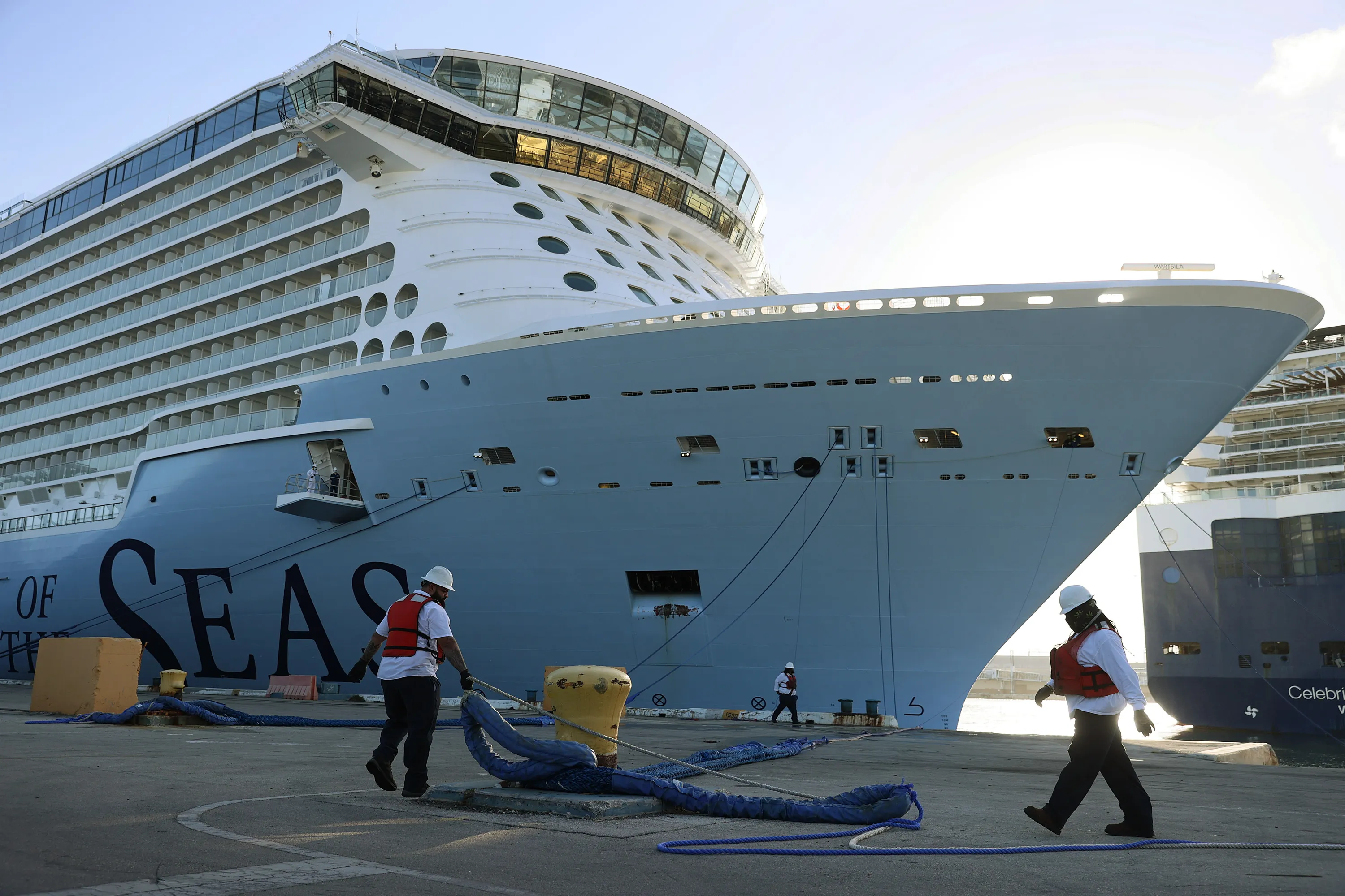 Dock workers use ropes to tie the Royal Caribbean’s Odyssey of The Seas to its berthing spot at Port Everglades&nbsp;in Fort Lauderdale, Florida on June 10.&nbsp;