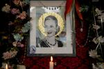 A candle stands near a picture of Argentina's late former first lady Maria Eva Duarte de Peron, better known as &quot;Evita&quot; at &quot;El Santa Evita&quot; restaurant in Buenos Aires, Argentina, Sunday, July 24, 2022. Argentines commemorate the 70th anniversary of the death of their most famous first lady on Tuesday, Evita who died of cancer on July 26, 1952, at the age of 33. (AP Photo/Natacha Pisarenko)