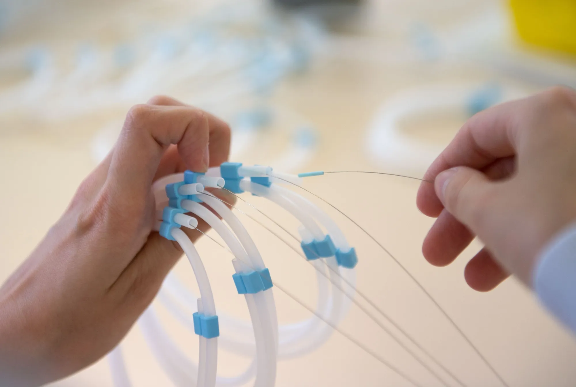 An employee assembles catheters.