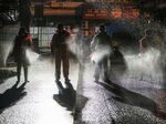 Workers spraying disinfectant on a road in Yunmeng county, Xiaogan city, in China's central Hubei province.