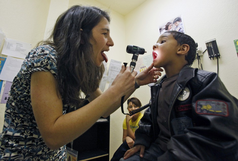 A pediatrician examines a young boy at a free clinic for the poor and uninsured in Los Angeles. 