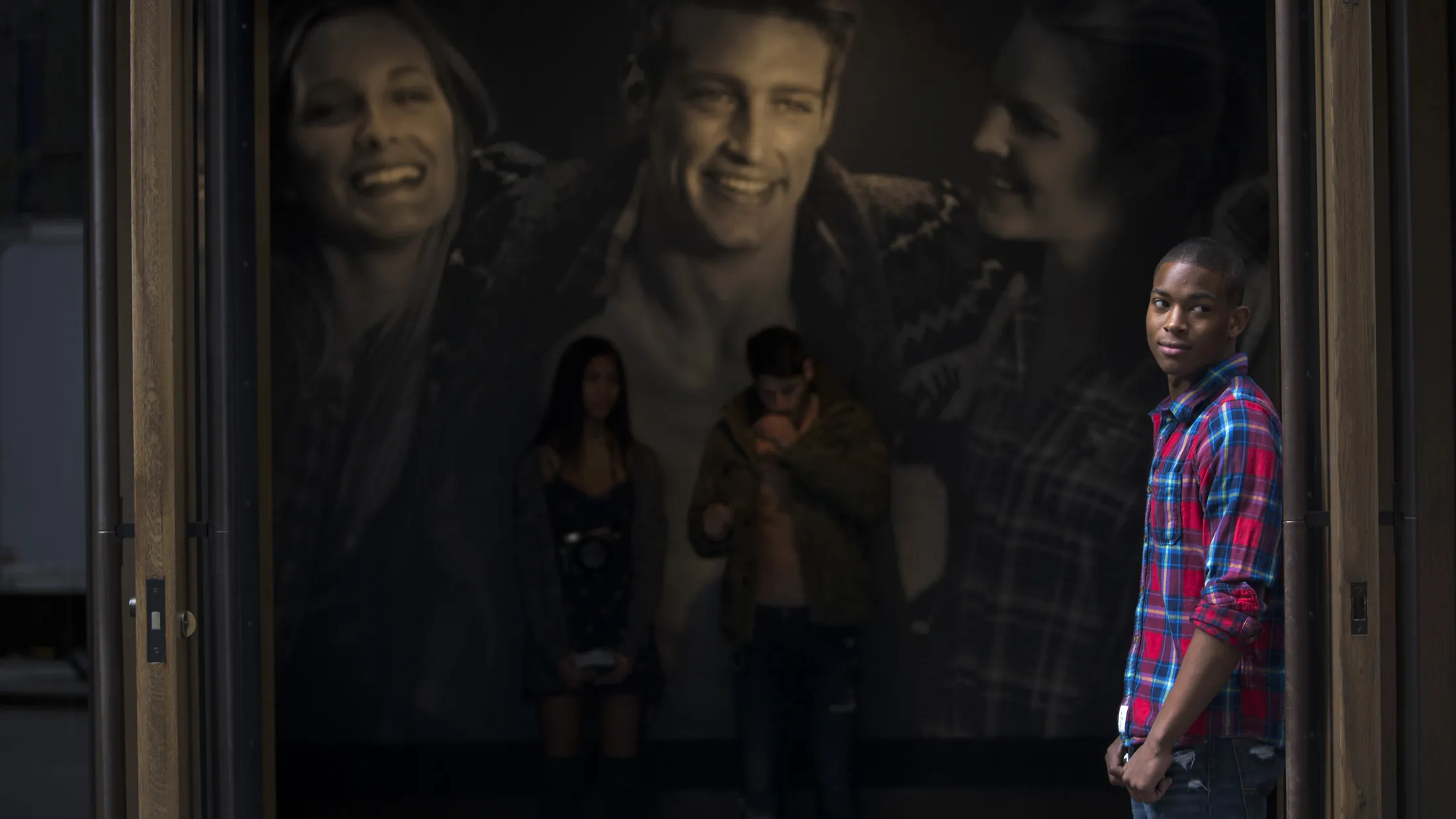 A greeter stands in the doorway of an Abercrombie &amp; Fitch location in New York.
