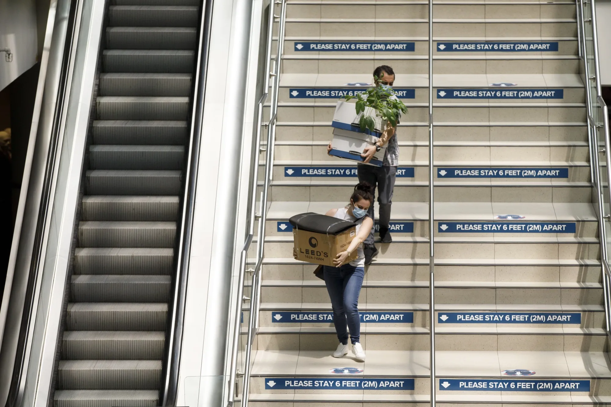 Shoppers carry purchases inside the Eaton Centre in Toronto, Ontario, Canada, on Wednesday, June 24, 2020. Canada's largest city has reopened restaurant patios, shops and swimming pools after officials determined that the Covid-19 virus is under control.