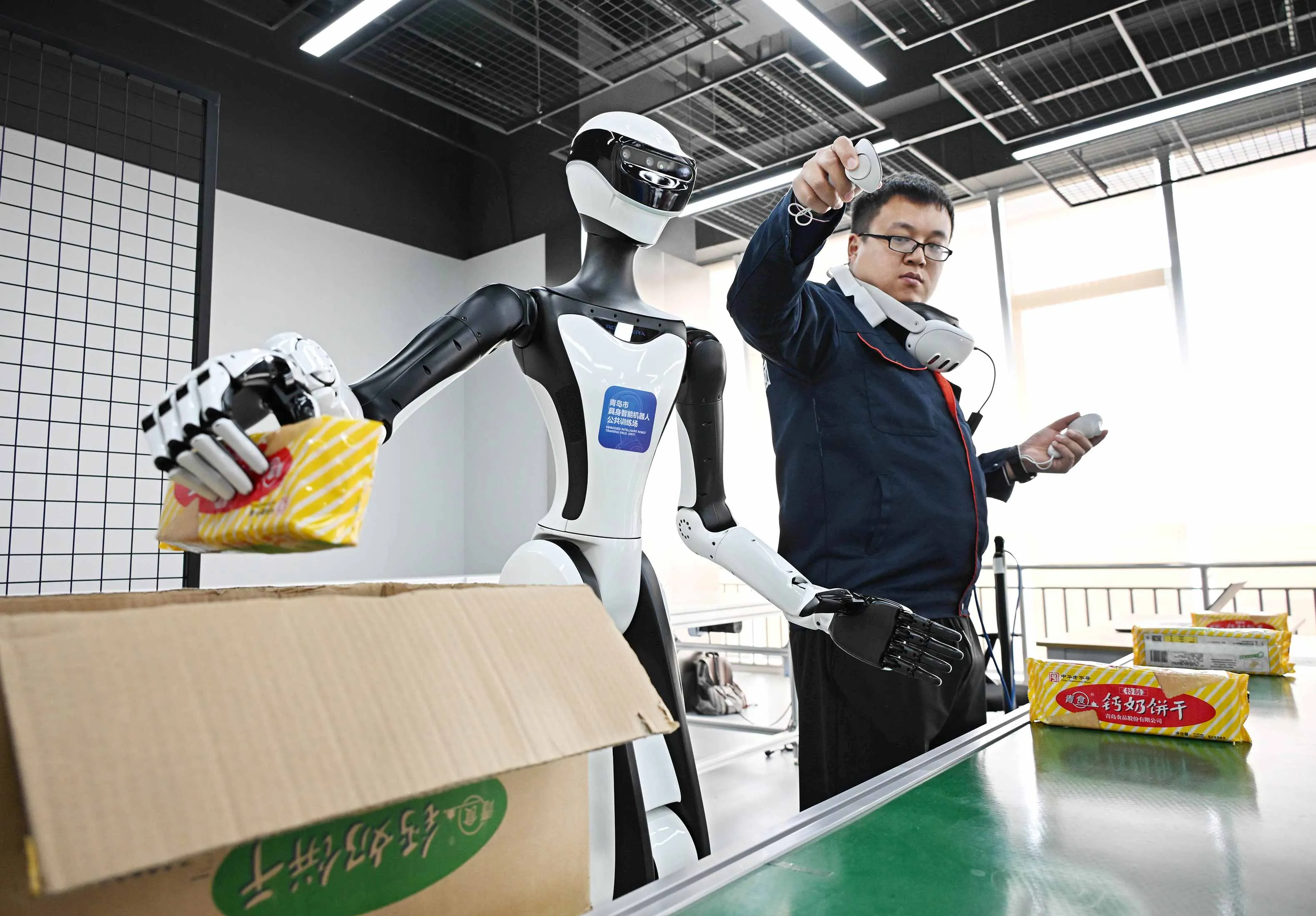 A trainer supervises a humanoid robot at an AI training center in Qingdao, China.