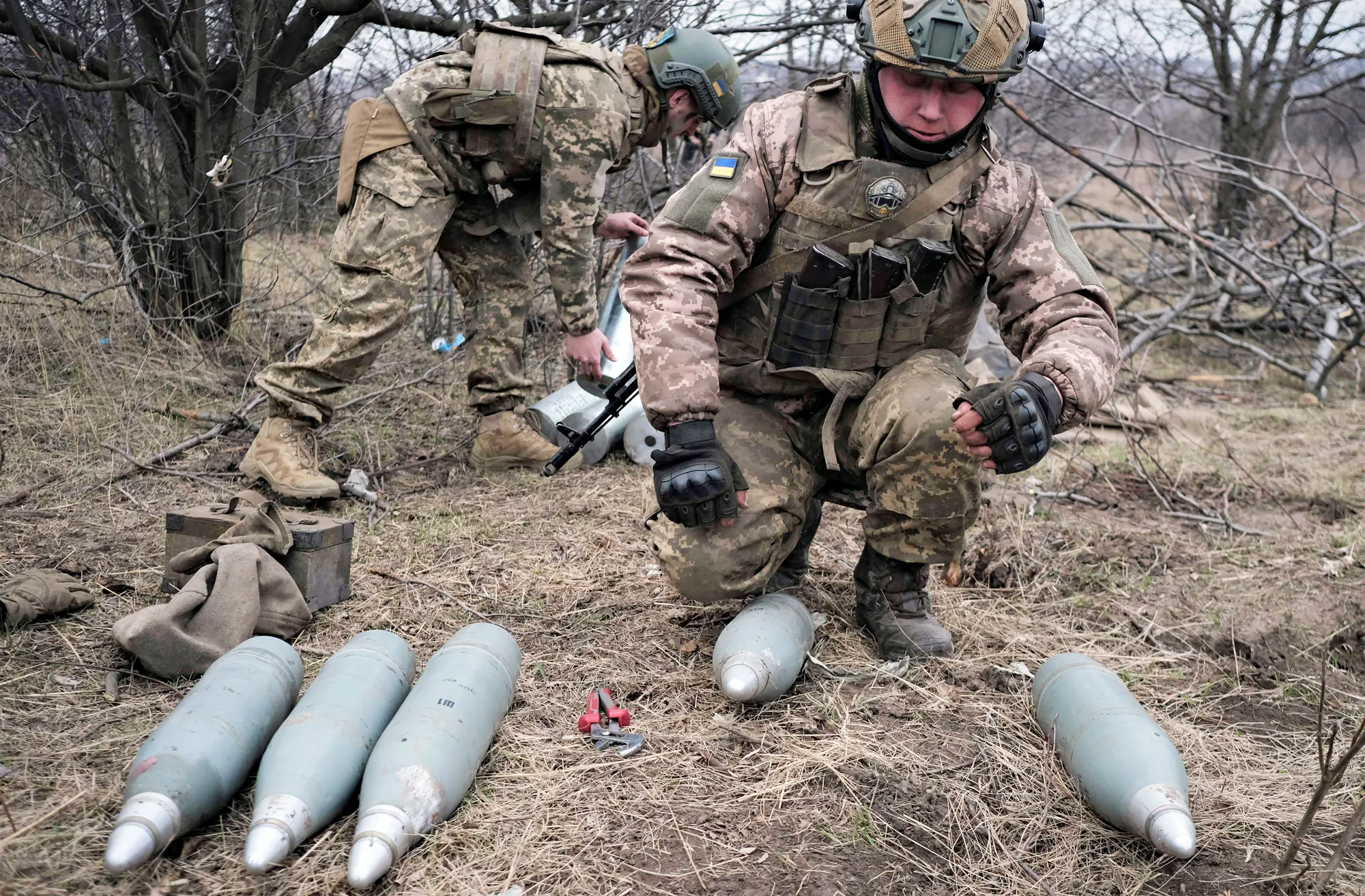 Ukrainian servicemen prepare artillery shells near Bakhmut.