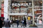 Pedestrians pass outside the Renault SA flagship store on the Champs Elysee in Paris.