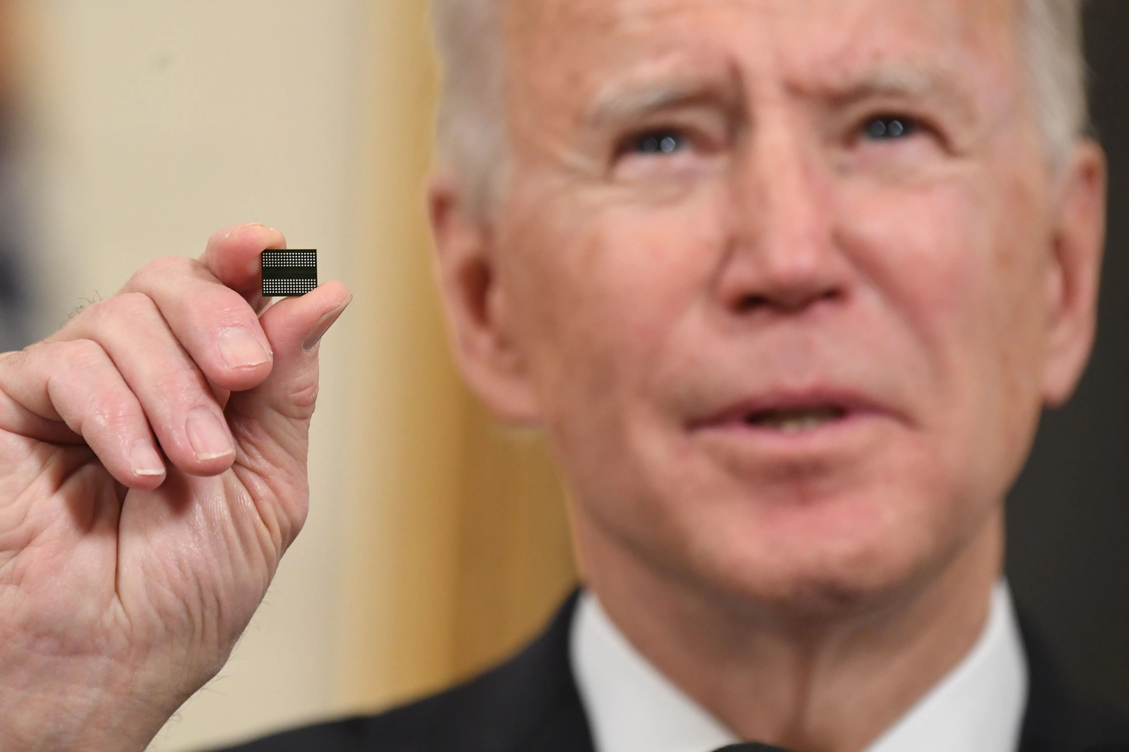 Joe Biden holds a microchip.&nbsp;