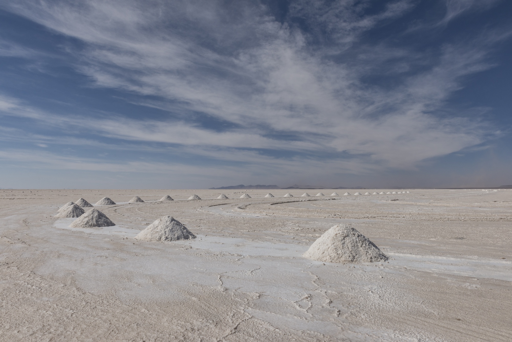 Mountains of salt stand at the Salar de Uyuni (Uyuni Salt Flats) in Potosi, Bolivia, on Friday, Dec. 9, 2016. Bolivia has the largest lithium deposits of any country, which are estimated to be about half of the world's supply. Photographer: Marcelo Perez del Carpio/Bloomberg