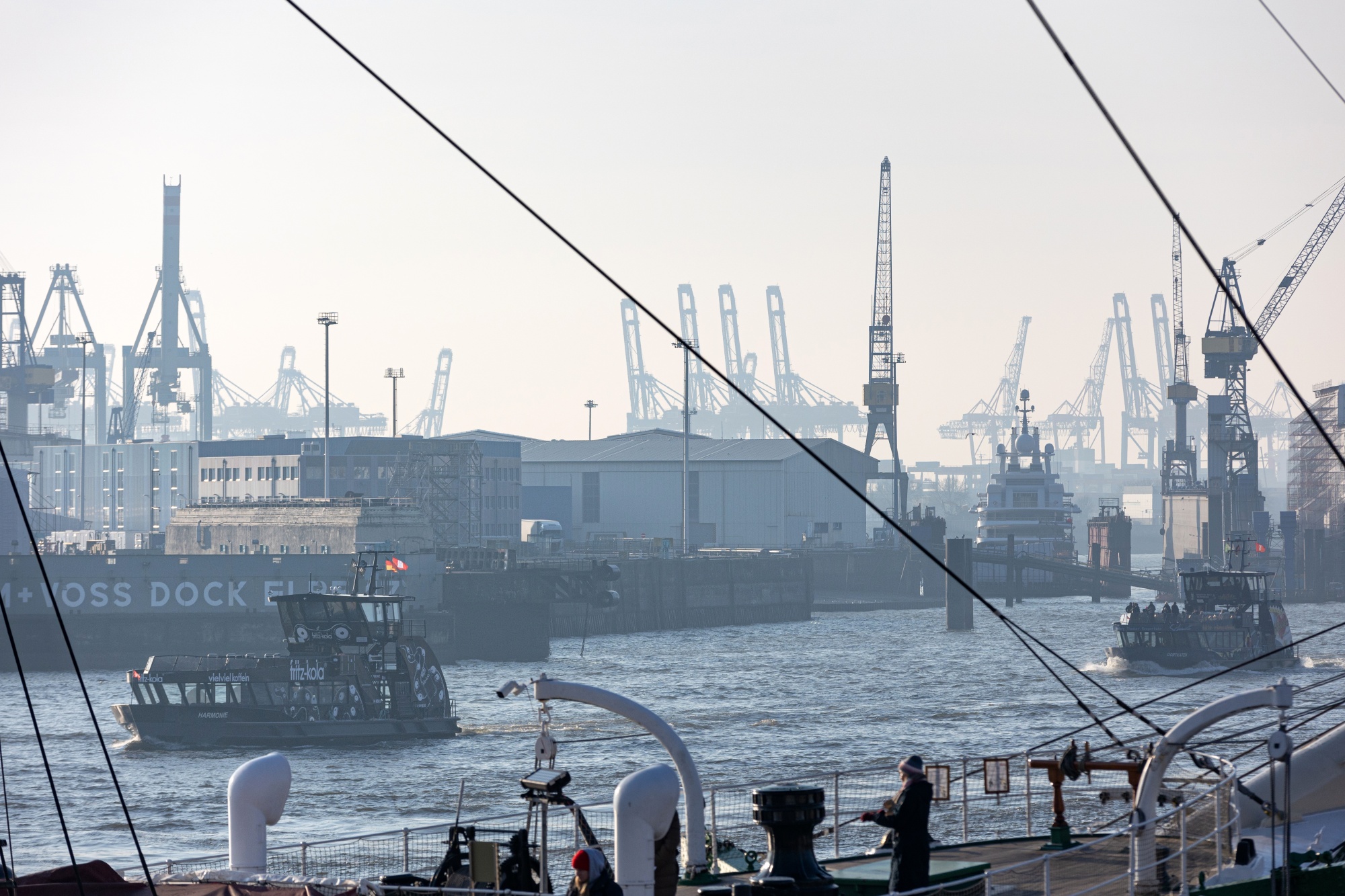 Harbor ferry boats pass the Port of Hamburg in Hamburg, Germany, on Monday, Feb. 3, 2025. A global trade war is heating up and Germany’s biggest seaport, like the country at large, is steeling itself for what may be to come.