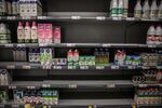 Empty shelves in the long-life milk section inside a supermarket in Barcelona, Spain.