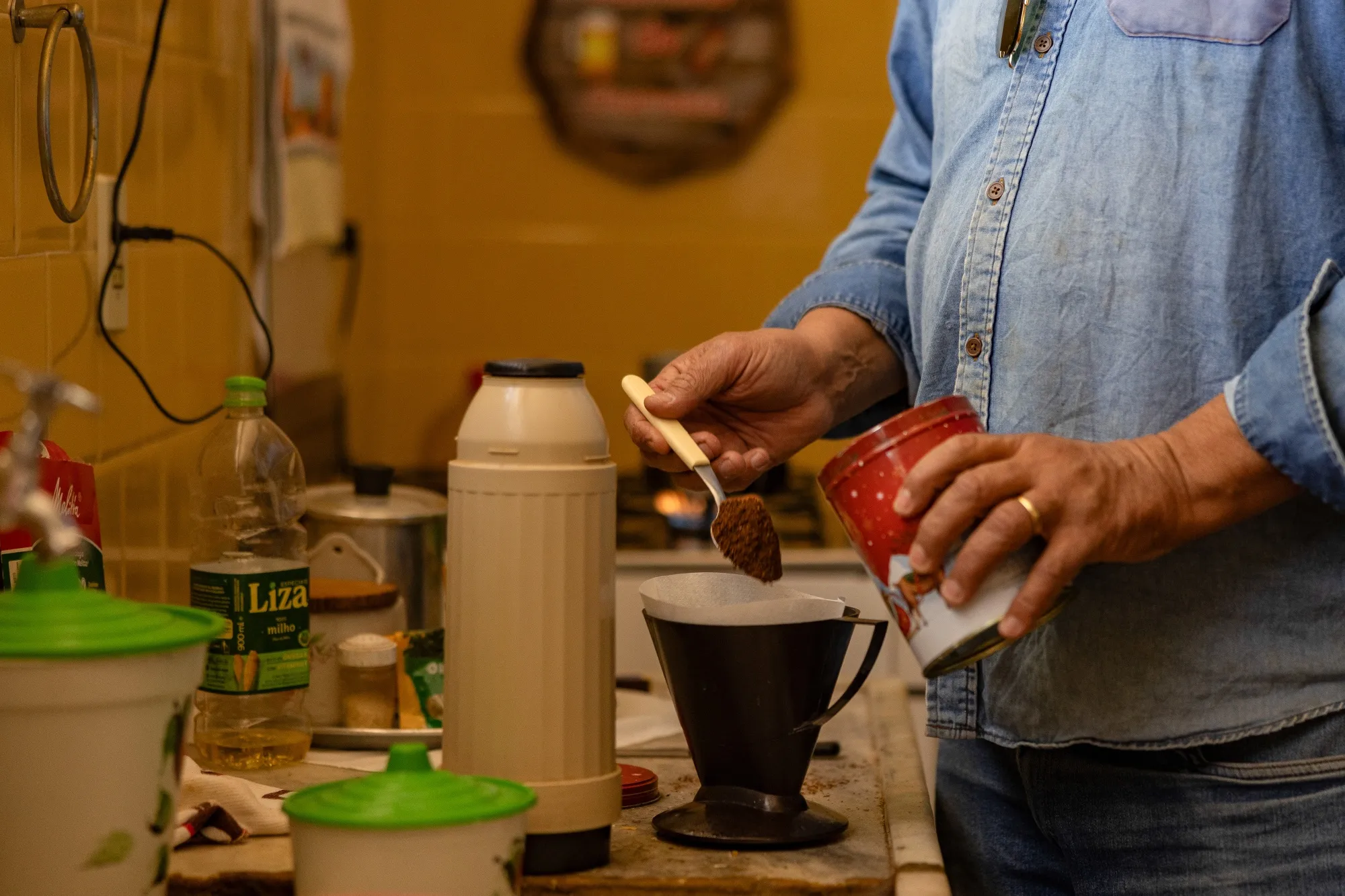 A worker prepares a cup of coffee during a harvest in Brazil.
