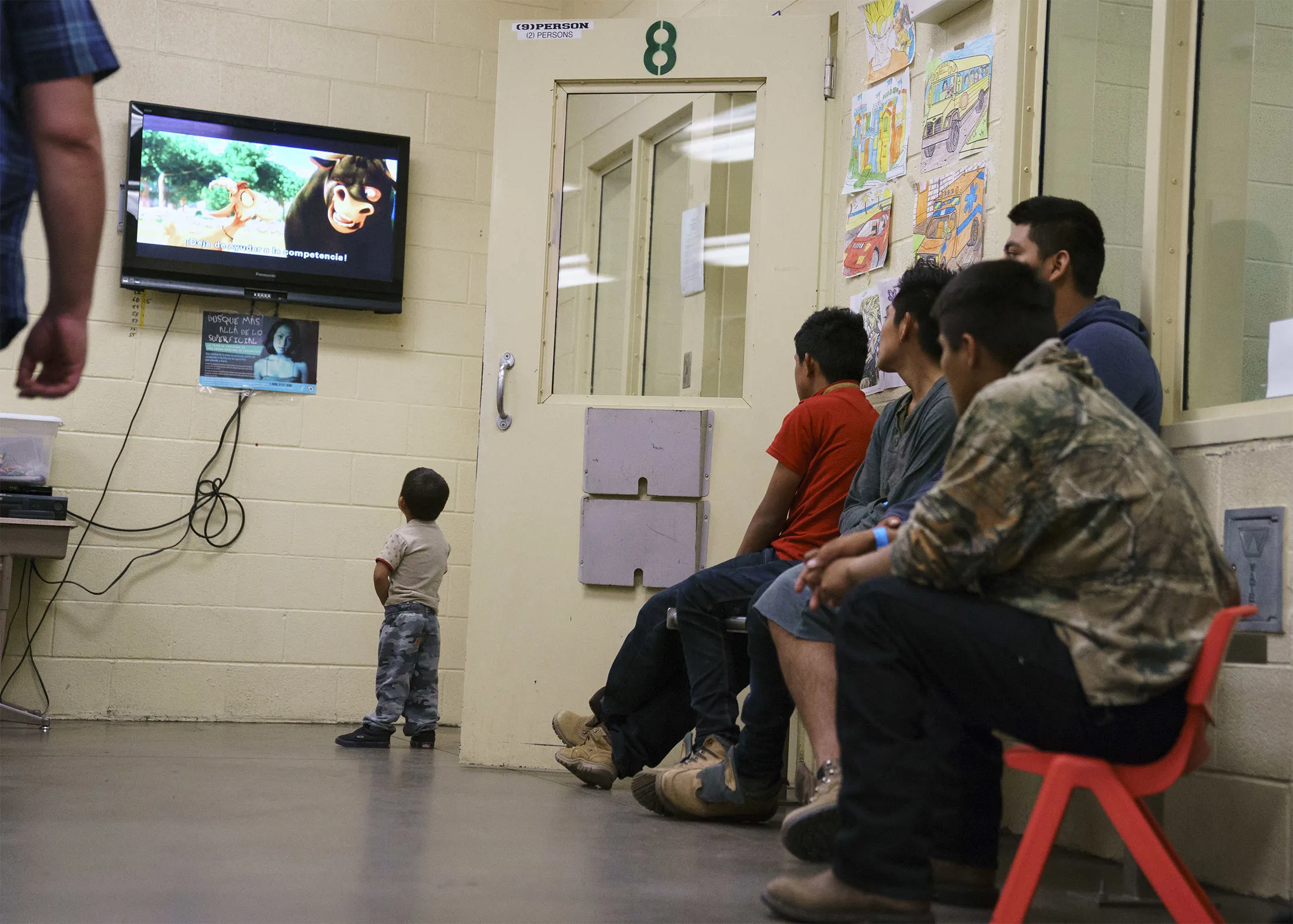 A child watches&nbsp;television in a processing center of a U.S. Customs border and protection facility.&nbsp;