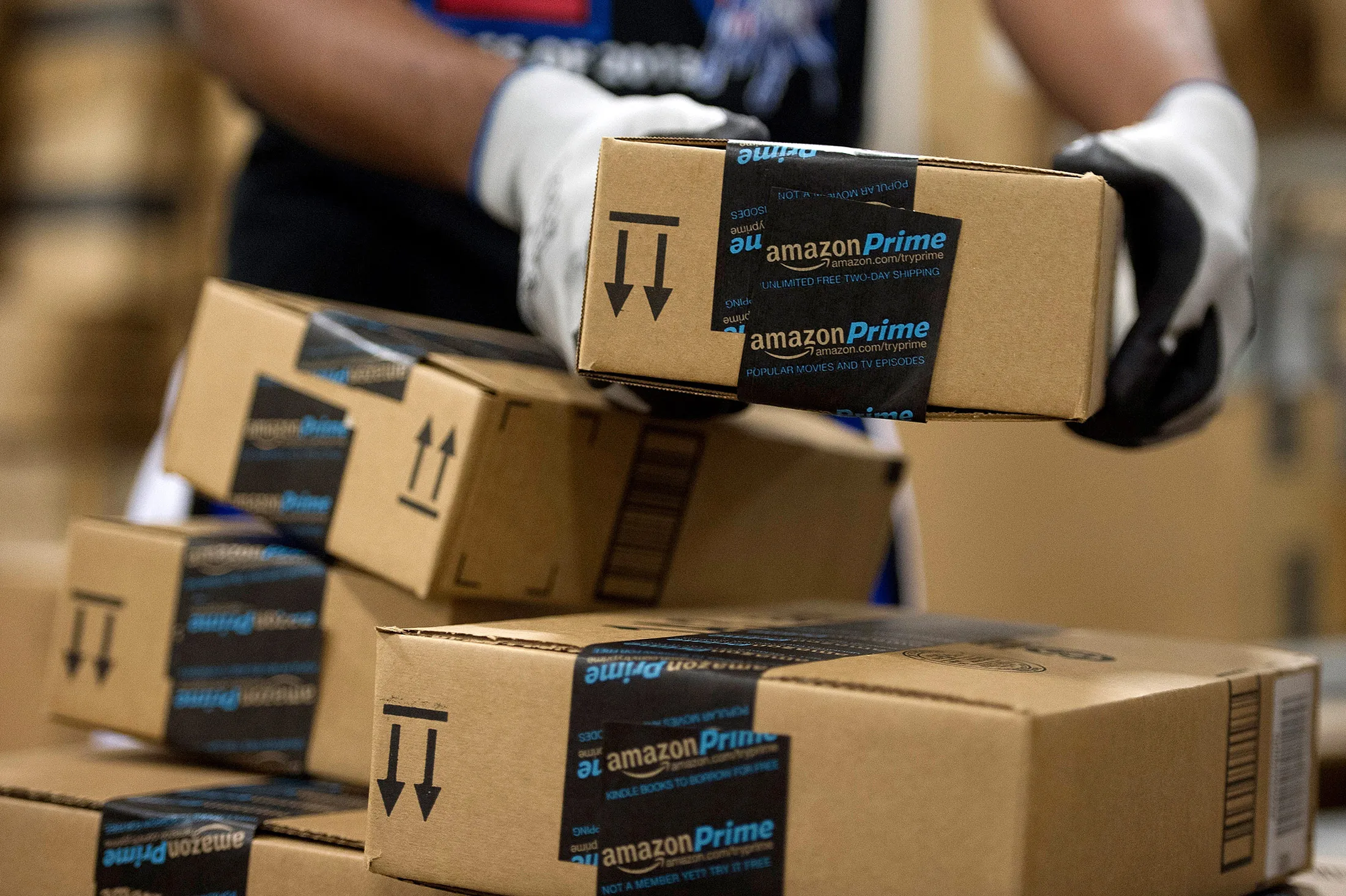 An employee stacks items to be shipped at the Amazon.com Inc. fulfillment center in Phoenix, Arizona.
