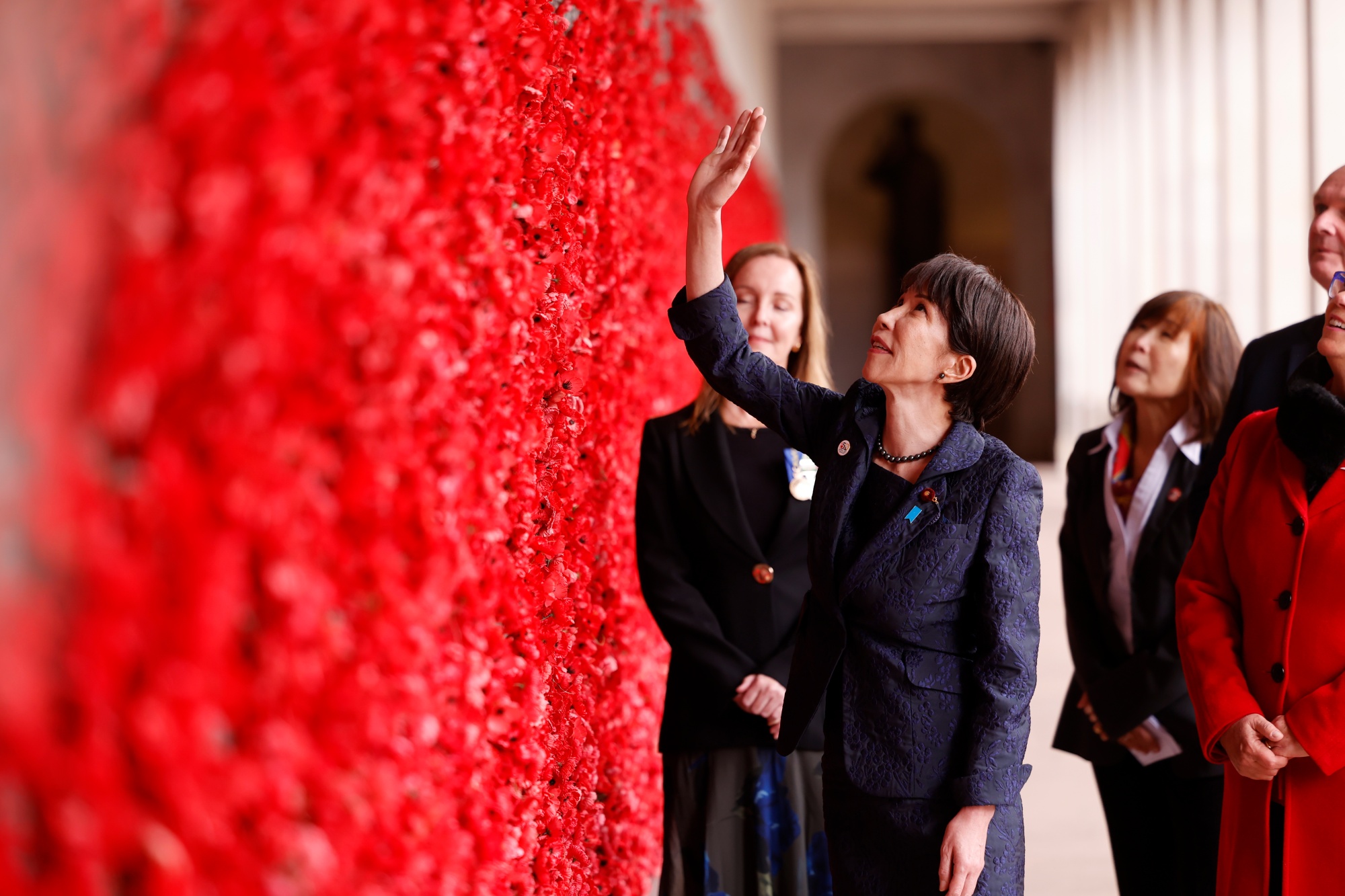 Sanae Takaichi, Japan's prime minister, center, visits the Australian War Memorial in Canberra, Australia, on Monday, May 4, 2026. Takaichi is visiting Australia to strengthen ties with one of her country’s strongest allies, as she seeks to build on an updated regional strategy that faces challenges from both Beijing and Washington. Photographer: Hilary Wardhaugh/Bloomberg
