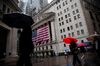 Pedestrians holding umbrellas walk in front of the New York Stock Exchange (NYSE) in New York, U.S., on Monday, Sept. 10, 2018. Stocks held early gains even as shares of Apple and Asia-based suppliers slumped after President Donald Trump insisted his trade war with China will spur more manufacturing jobs in the U.S.