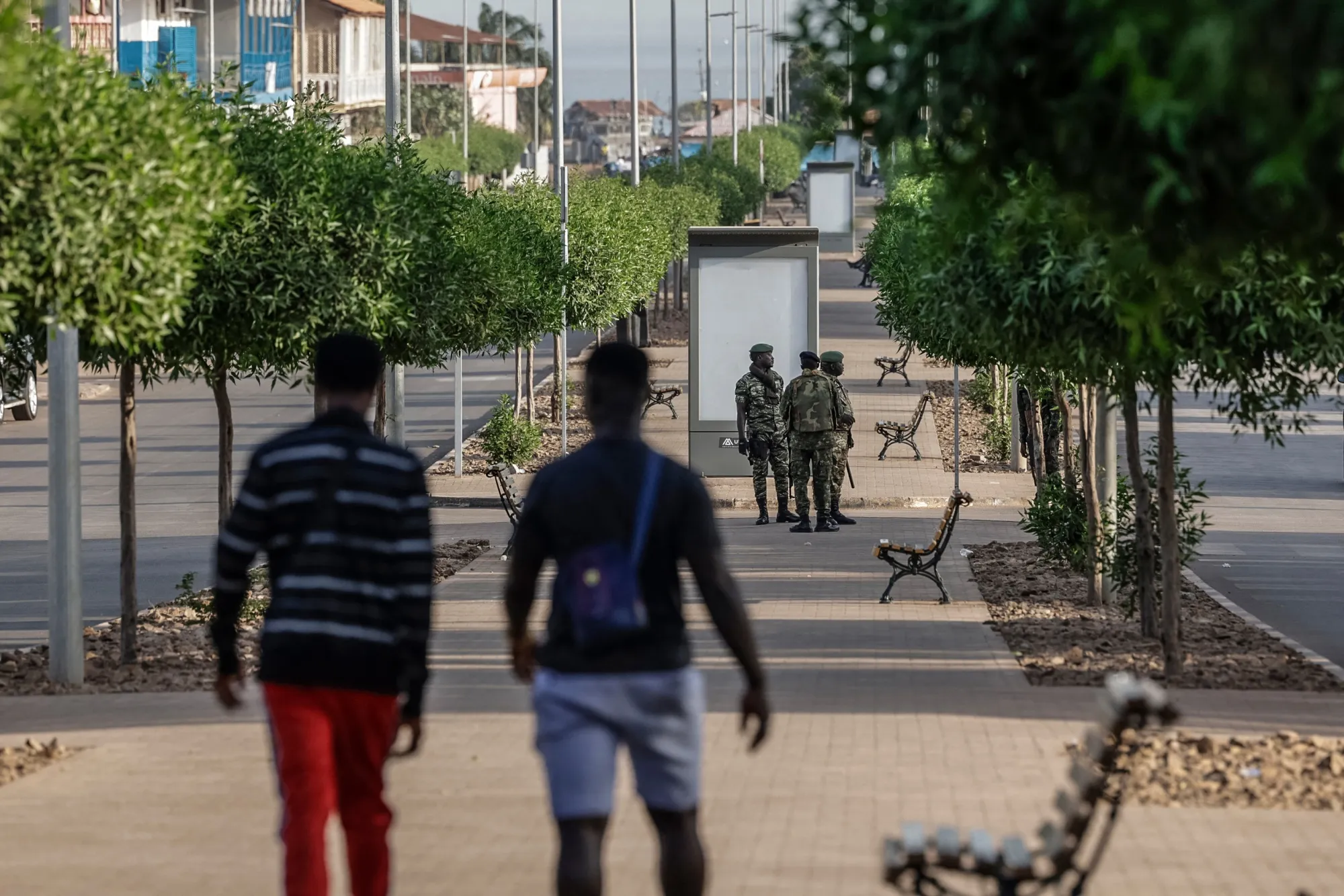 Soldiers patrol a street in Bissau on Nov. 26.