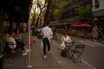 Customers sit in outdoor dining areas of restaurants in New York City.&nbsp;