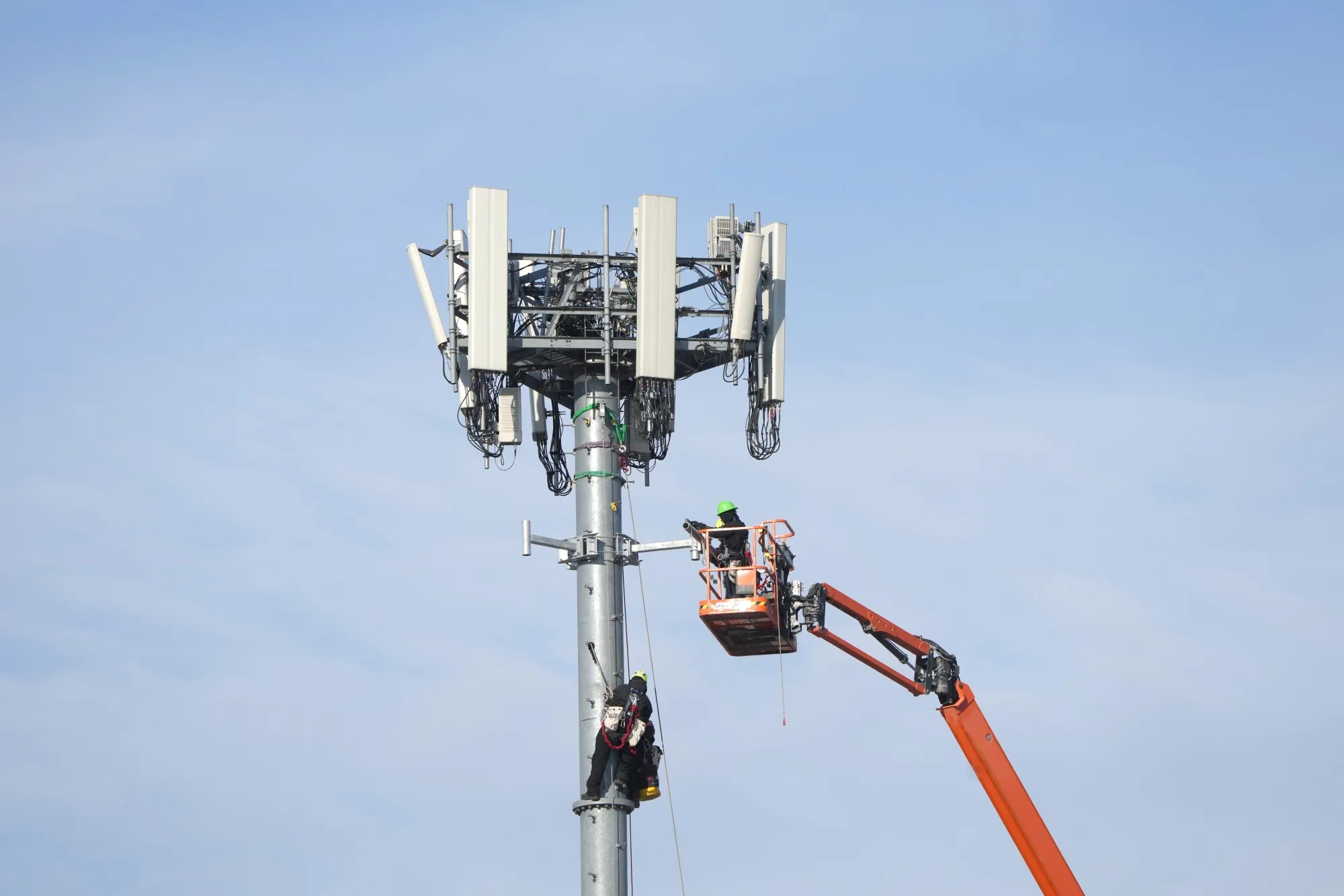 Workers install equipment on a 5G cell tower in Salt Lake City, Utah.