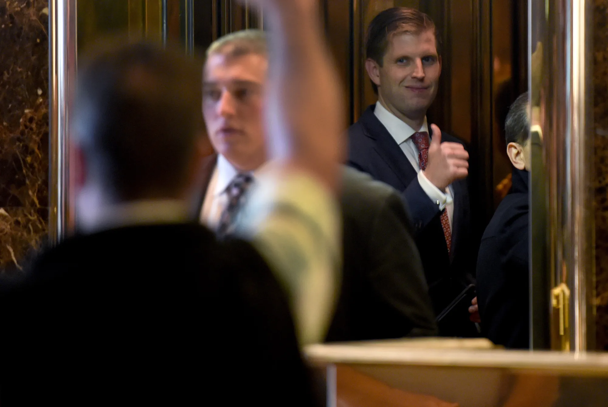 Eric Trump gives thumbs-up to a supporter as he gets on the elevator at Trump Tower on 5th Avenue in New York, on Nov. 11, 2016 .

